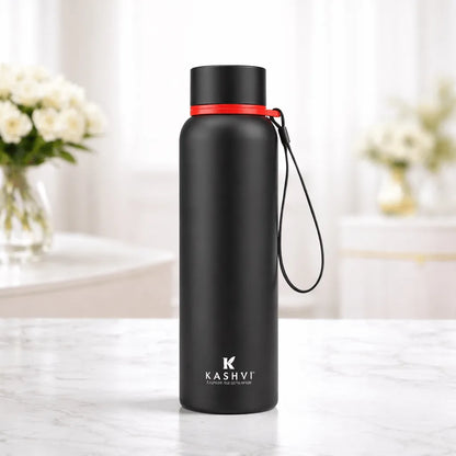 Black water bottle with red accent on a marble surface, brand 'Kashvi' visible