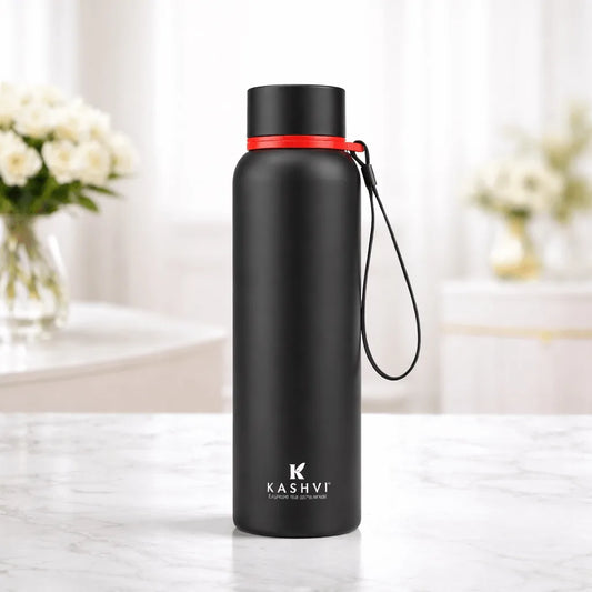 Black water bottle with red accent on a marble surface, brand 'Kashvi' visible