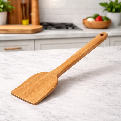 Wooden spatula on a marble countertop with a kitchen background