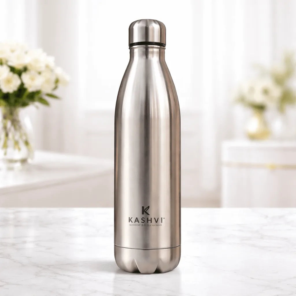Stainless steel water bottle with 'Kashvi' branding on a white surface with a blurred background