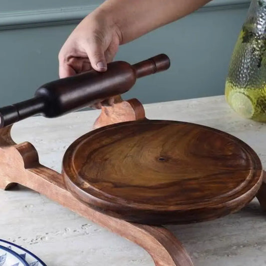 Person using a wooden rolling pin on a wooden tray with a neutral background