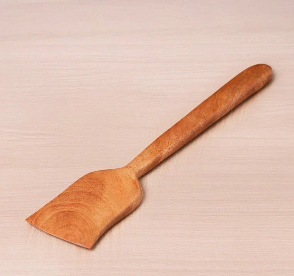 Wooden spatula on a beige background